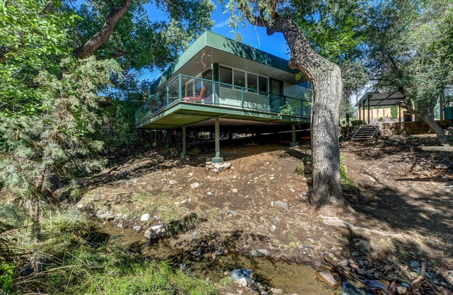 Modern cabin hidden among the trees-- Unwind and relax on the porch creek-side.