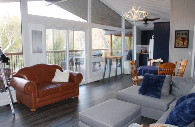 Modern log cabin with wrap around deck on Little Kennisis