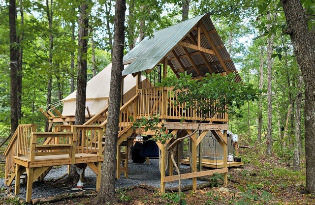 Mountain Bell tent Tree house providing views of surrounding mountains and lake.