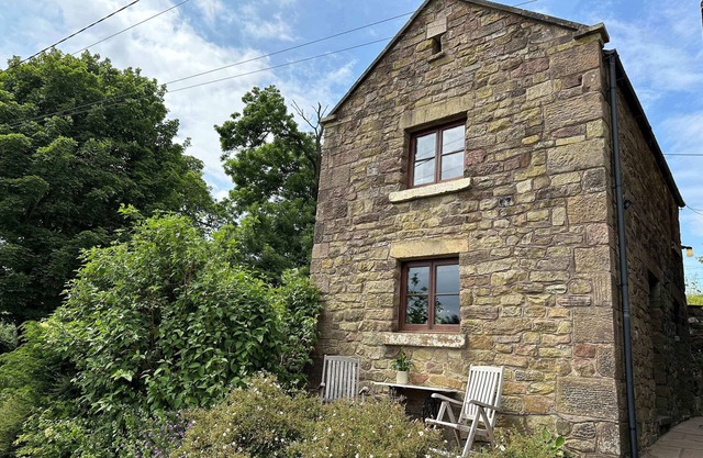 OLD POST OFFICE BARN, with a garden in Leek