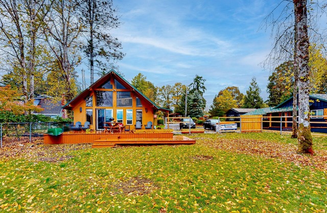 Peaceful lakeside home with wood-burning fireplace, patio, loft, & washer/dryer