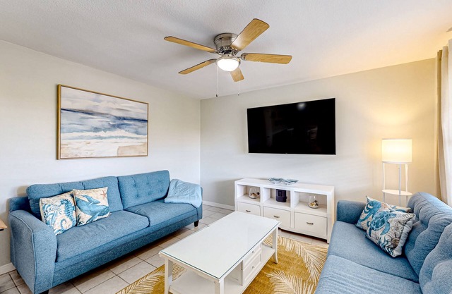 Peaceful, seaside-themed condo with a full kitchen, shared patio, & central AC
