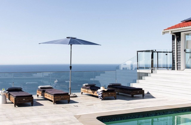Positioned on a clifftop, this luxury beach house enjoys ocean views.
