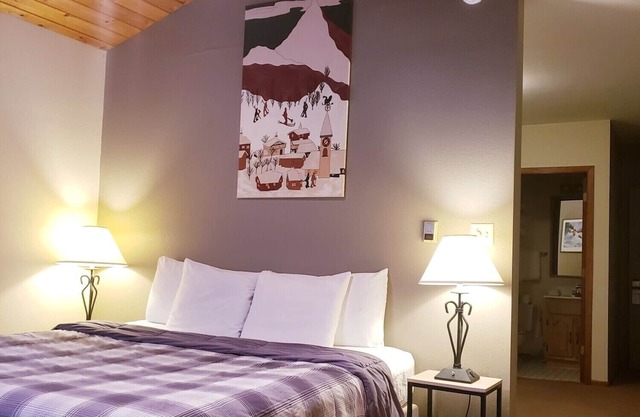 Private King Suite ideal for couples/romantic stays, and single travelers featuring a beautiful knotty pine vaulted ceiling. Dog friendly!