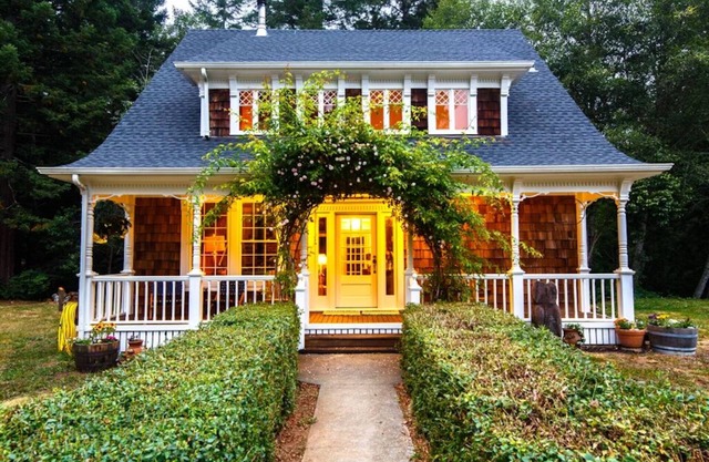 Redwood coastal custom farmhouse surrounded by sunshine and flowers