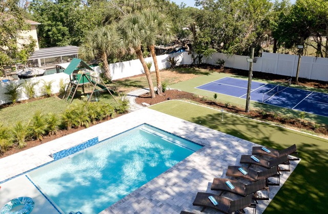 Resort-style home with pickleball court, mini-golf, playground & large htd pool
