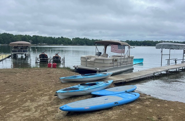 Beautiful lake home on the water with sandy beach and clear water.