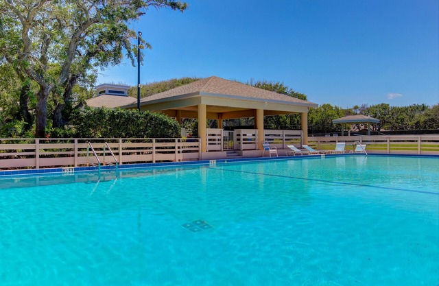 Row-end condo with pool, clubhouse, tennis, & walk to beach