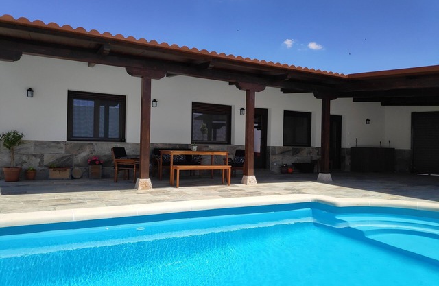 Rural house with pool and garden.