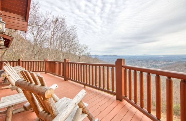 Rustic mountain-view home with deck, fire pit, hot tub, fireplace, & game room