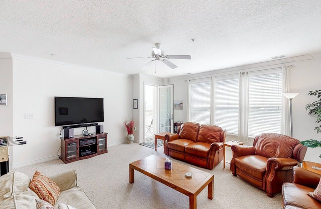 Second-floor, ocean view condo with balcony, foosball, WiFi & on-site pool/gym
