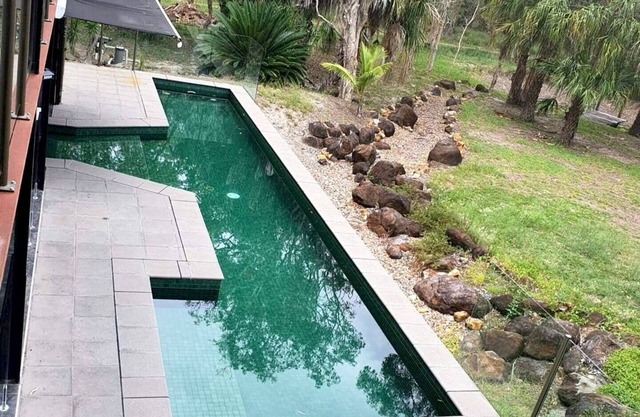 Serenity a Tropical oasis set on 4 acres of land with pool.