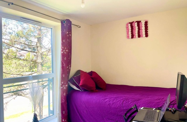 Spacious room with study table next to university