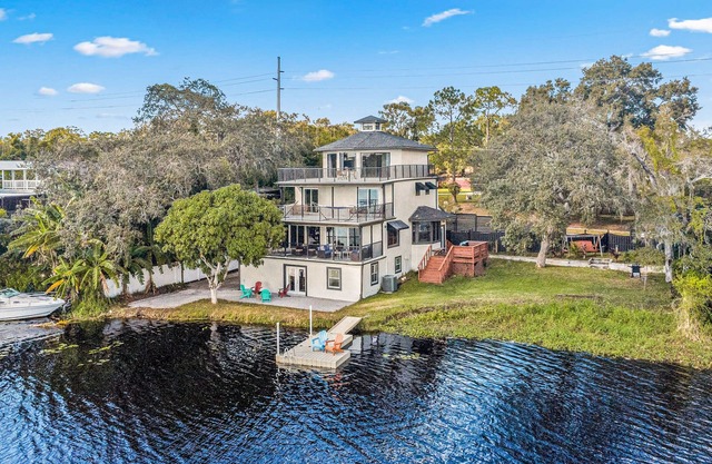 Sprawling river view estate with game room, dock, kayaks, grill, & fishing gear