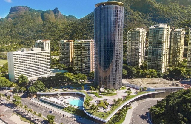 Stay in a work of art with a panoramic bath overlooking sea and mountains.
