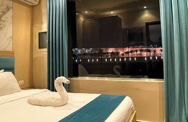"Stay in Luxury: Hotel Room with Stunning Grand Egyptian Museum View"
