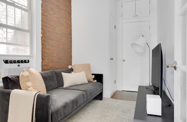 Sunlit LES 1BR w/ W/D, steps to B/D train, by Blueground