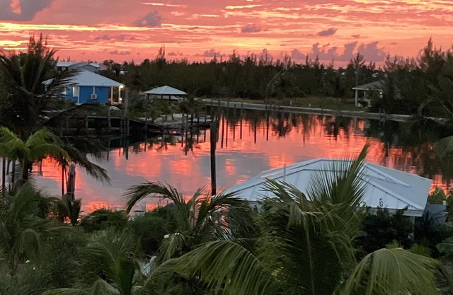 Sunset condo with private deck and dock . Steps away from Windward beach.