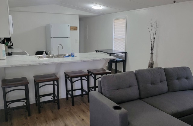 Surrounded by sweetgum and maple trees, this house is perfect for some R & R.
