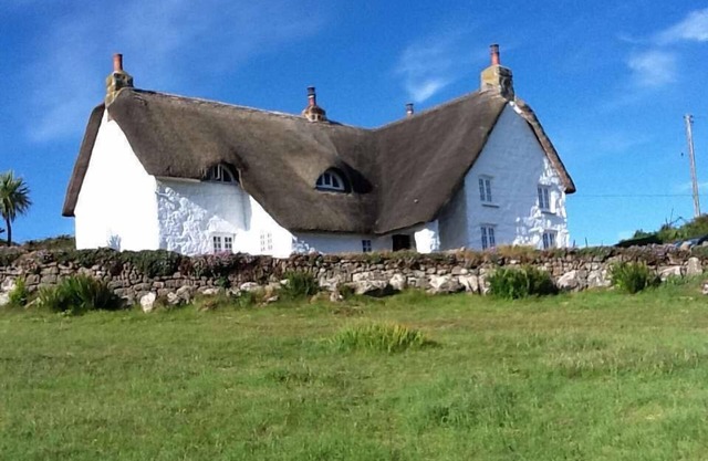 Thatched house by a Cornish beach