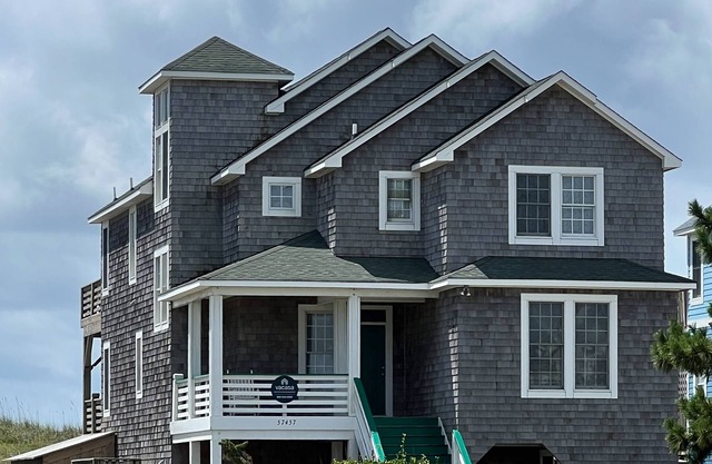 Three-story beachfront home with private pool, hot tub, decks, & ocean views