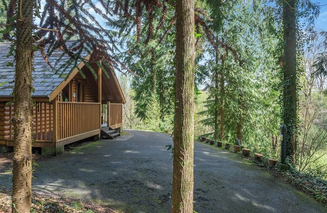 Timber lodge set high in an elevated secluded position with a view of the lake.