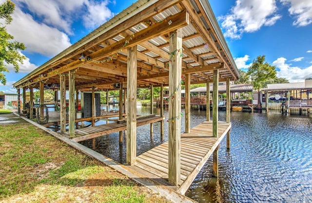 Tropical Lake House with waterfront tiki bar and wrap around porch