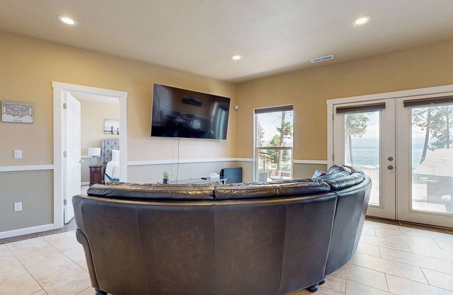 Two-level lakefront home with hot tub access, game room, AC, W/D, & lovely patio