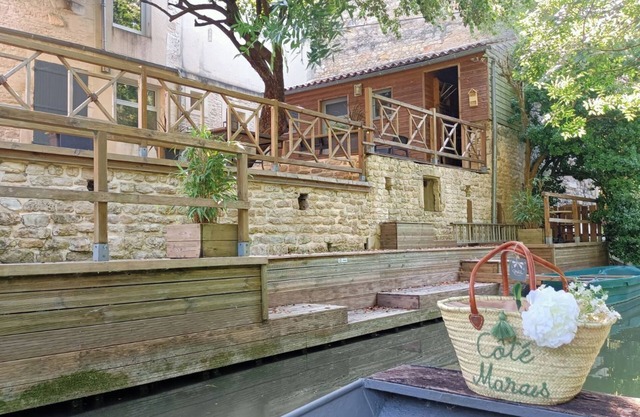 Typical house in the Marais Poitevin with private pontoon and rowing boat
