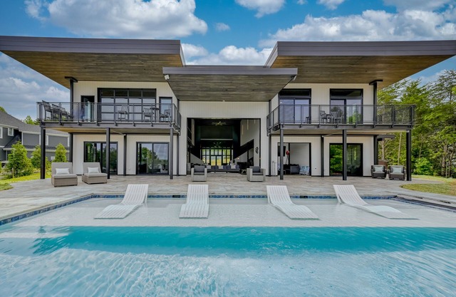 Unique lake house with infinity pool, hot tub, modern interior, & views