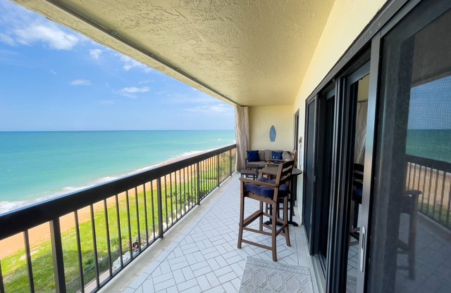 Updated direct oceanfront corner condo with private balcony, heated pool and garage