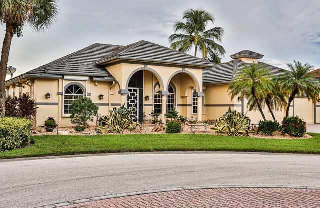 Upscale waterfront home with private dock, saltwater pool, lanai, grill, & W/D