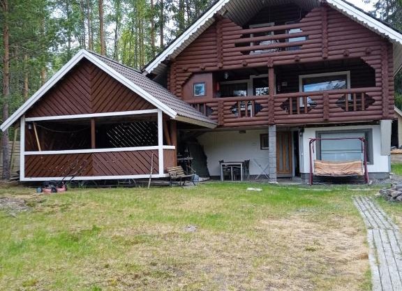 Viihtyisä hirsimökki järven rannalla