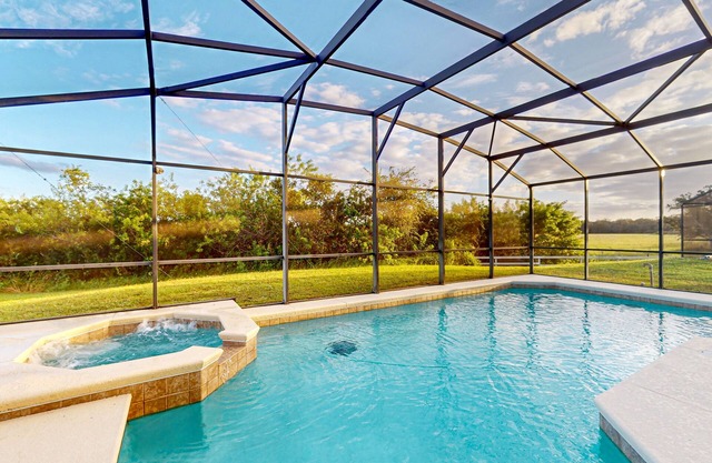 Water-view home with private pool, screened patio, on-site gym & tennis