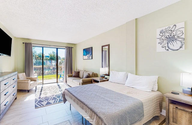 Waterfront condo featuring a lovely patio with views, AC, & pool access