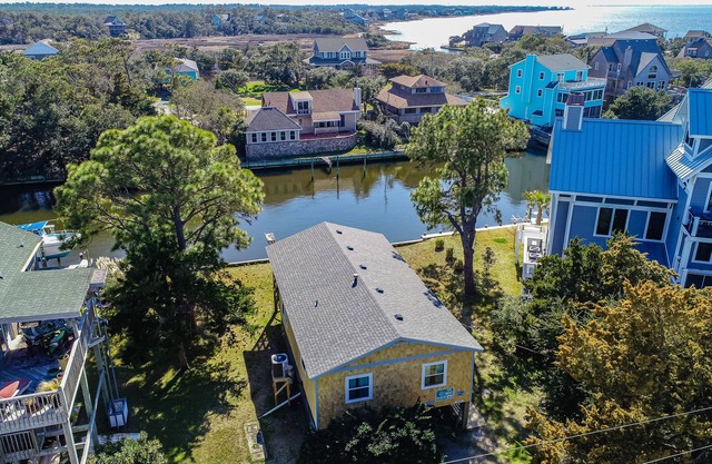 Waterfront home on a scenic canal with a dock, screened porch & fast WiFi