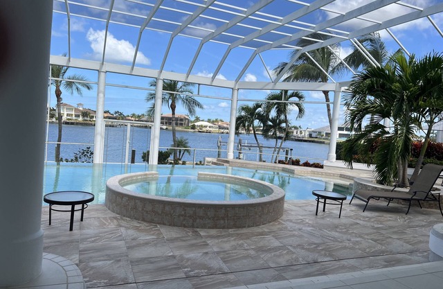 Waterfront home on Marco Island, large pool, & dock. Sleeps 18, many amenities.