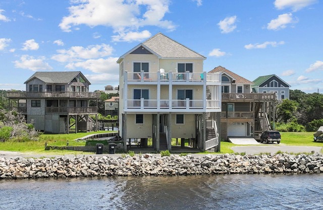 Waterfront home with boat dock, private pool, & balcony with ocean view