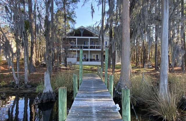 Waterfront home with dock and community boat ramp and HUGE screened in porch.