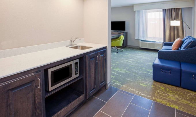 Sioux City Maison | 2 Connecting Suites with Two Beds and Two Sofabeds at a Full Service Hotel by Suiteness