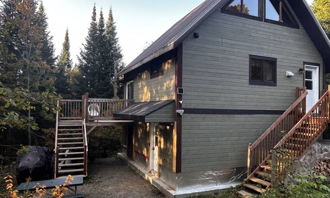 Notre-Dame-Des-Bois Cabine | A cozy rustic mountain side cabin with a small river on the property.