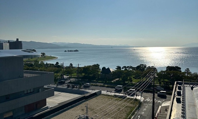 Yunokawa Onsen Appartement | A panoramic view of Lake ShinjiSpacious living s / Matsue Shimane