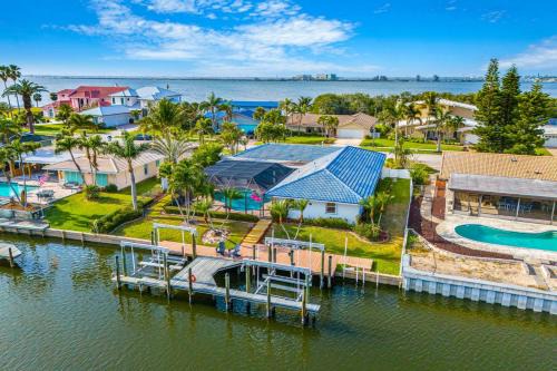 Cocoa Isles Villa | Casa De Olas - Waterfront Luxe Home - Heated Pool - Boat Lift - Minutes to Beach