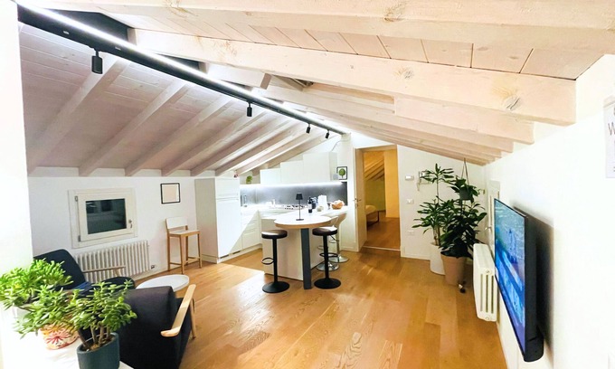 Bassano del Grappa Appartement | Casa Tonde, a modern attic with exposed beams.