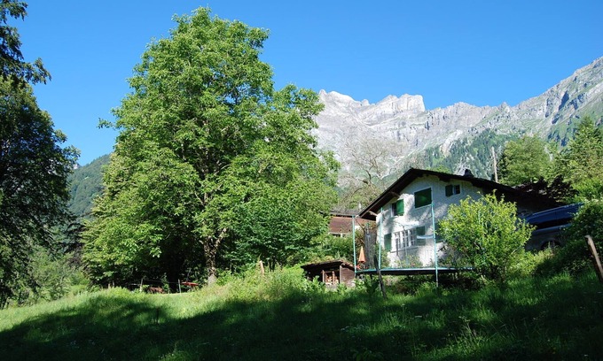 Schwanden Chalet De Ski | Chalet on the edge of the forest with a view of the waterfall right next door