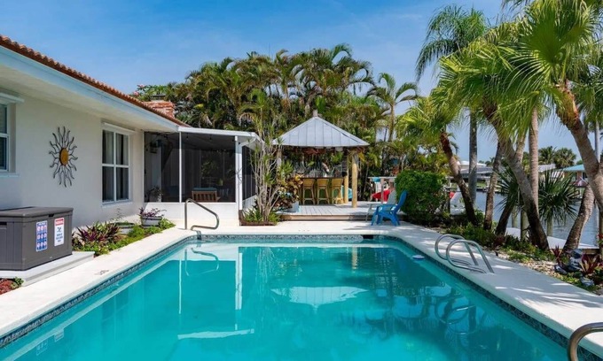 Cocoa Isles Maison | Cocoa Beach Waterfront Home with Tiki Bar and Pool