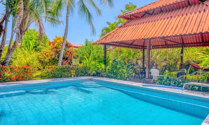 Barrio Ricos y Famosos Maison | Colorful, dog-friendly home with private pool, W/D, & lush setting