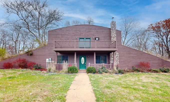 Banner Maison | Cozy Hobbit House inspired home with large balcony and front porch