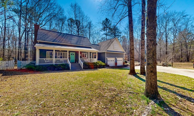 Forsyth Maison | Creekside home with firepit, yard games, deck, wood stove, & W/D