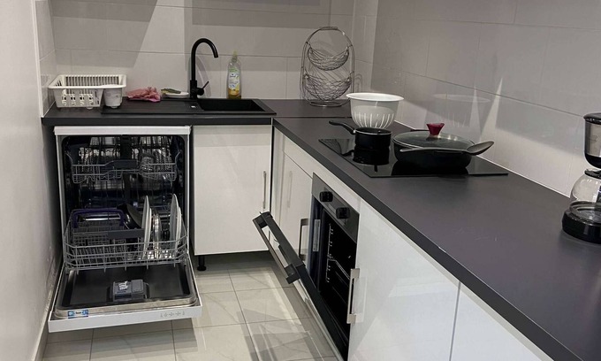 Saint-Brice-sous-Foret Appartement | L'appartement dispose d'un lit, d'un canapé-lit et d'une cuisine avec un réfrigérateur